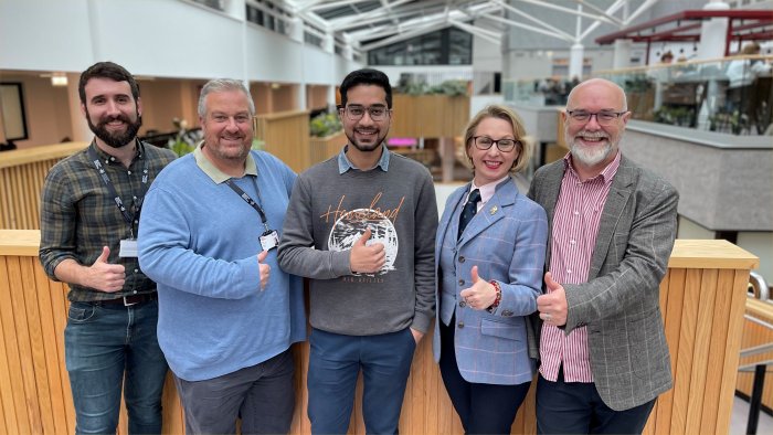 A picture of colleagues from Sheffield Hallam and Guildhawk giving the thumbs up to the collaboration