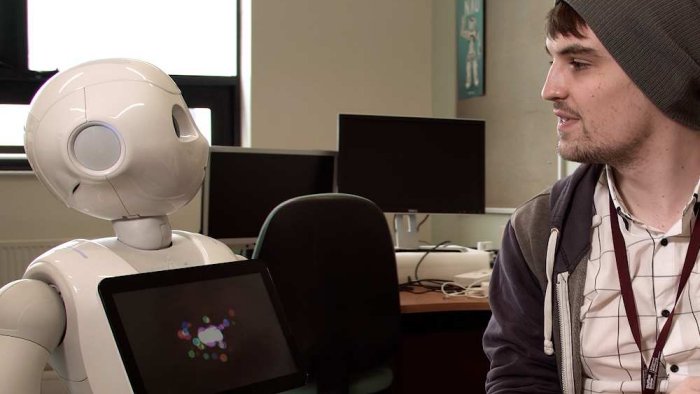 A student interacting with a Pepper robot