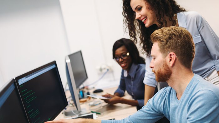 People working on a computer with support