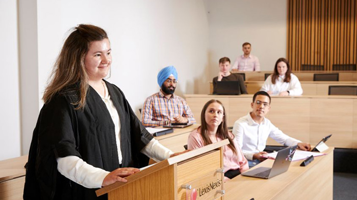 student stood speaking in replica courtroom