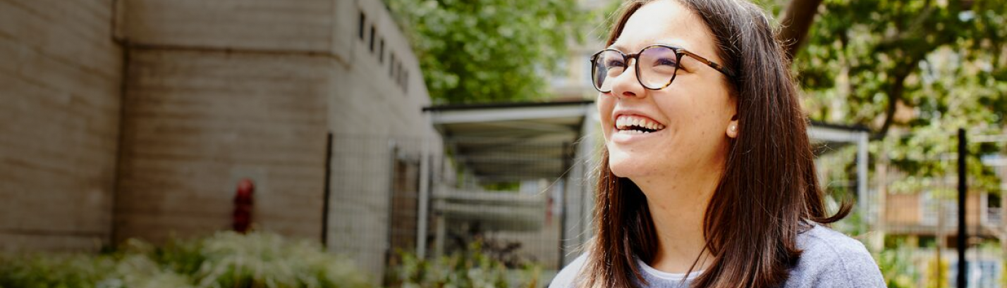 Student smiling outside building