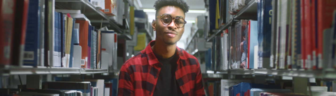 Student in library stacks