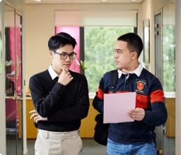 Two law students talking in a classroom