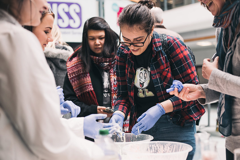 Students and lab assistants taking part in an experiment