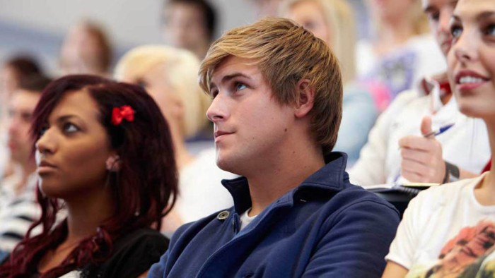 Students sat in a lecture hall listening to a lecture