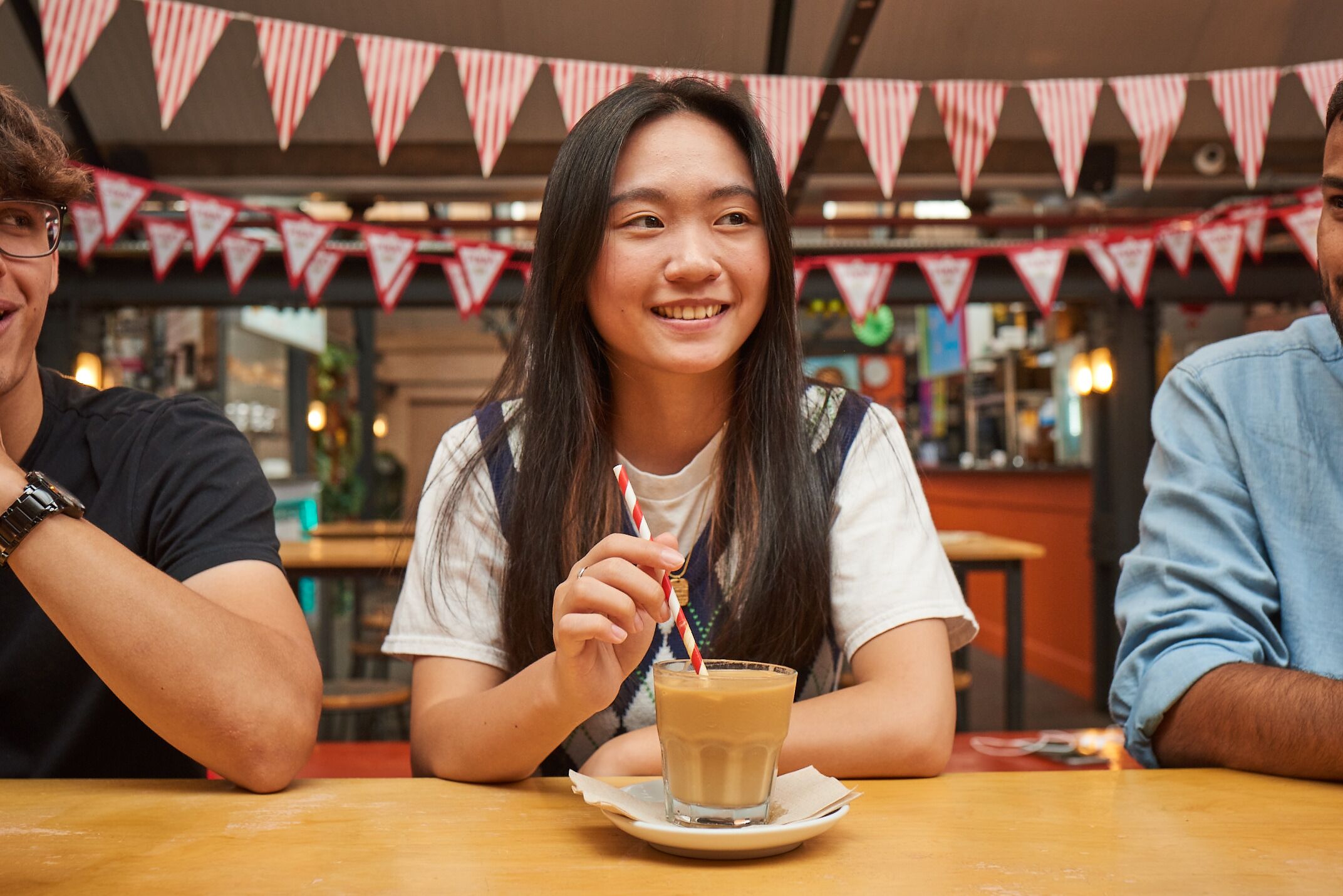 Person sitting with coffee looking away from camera