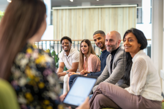 Group of people listening to educator