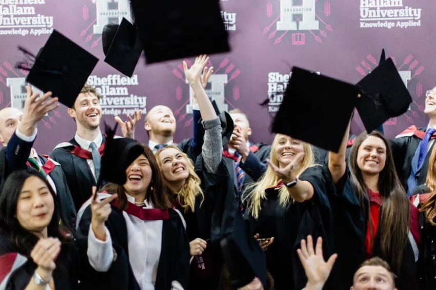 Graduates celebrating by chucking hats in the air