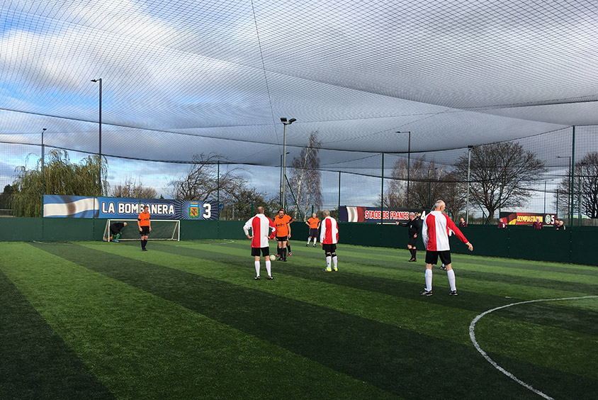 Several players on a five a side football pitch 