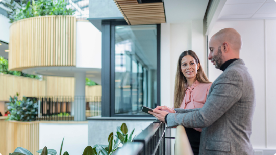 Man and women looking over balcony