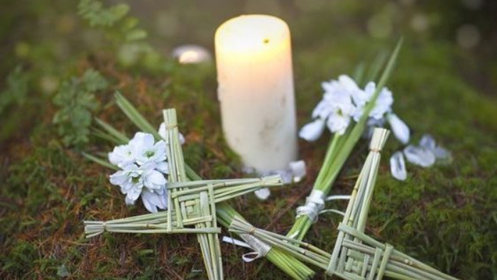 Candle, flowers and pagan symbol