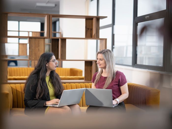 Two women with laptops