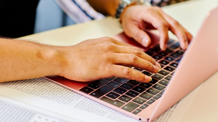 laptop with hands typing