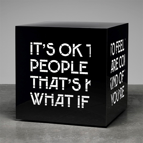 A black lightbox design, with words of poetry cut out, allowing the light to shine through.