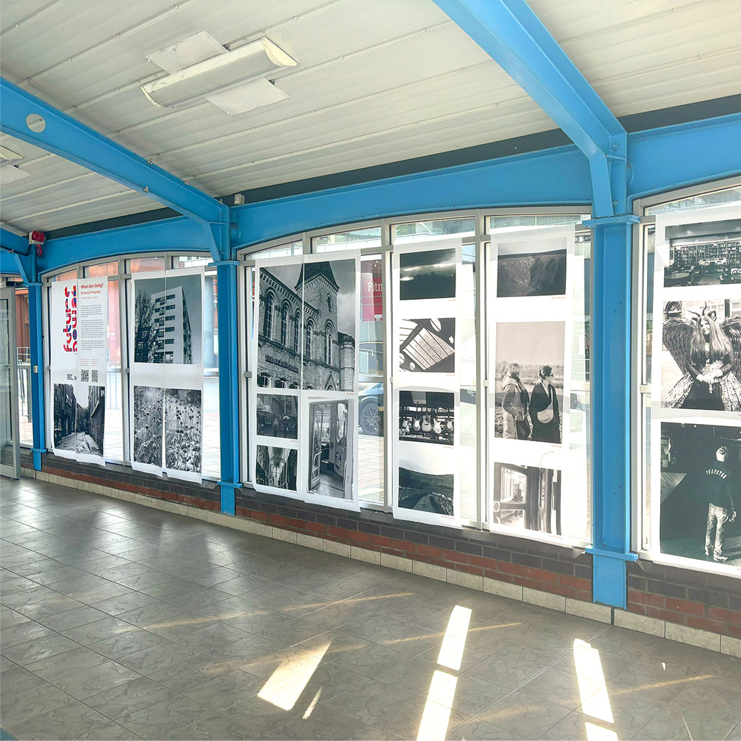 A photography exhibition, printed onto paper banners and hung in the windows of the Sheffield Interchange space.