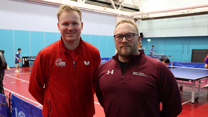 Gavin Evans (left) and Dave Hembrough stood in front of people playing table tennis