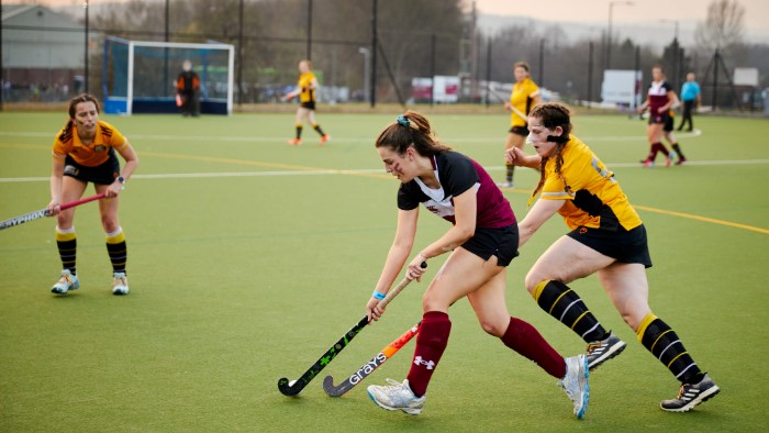 Girls playing hockey.