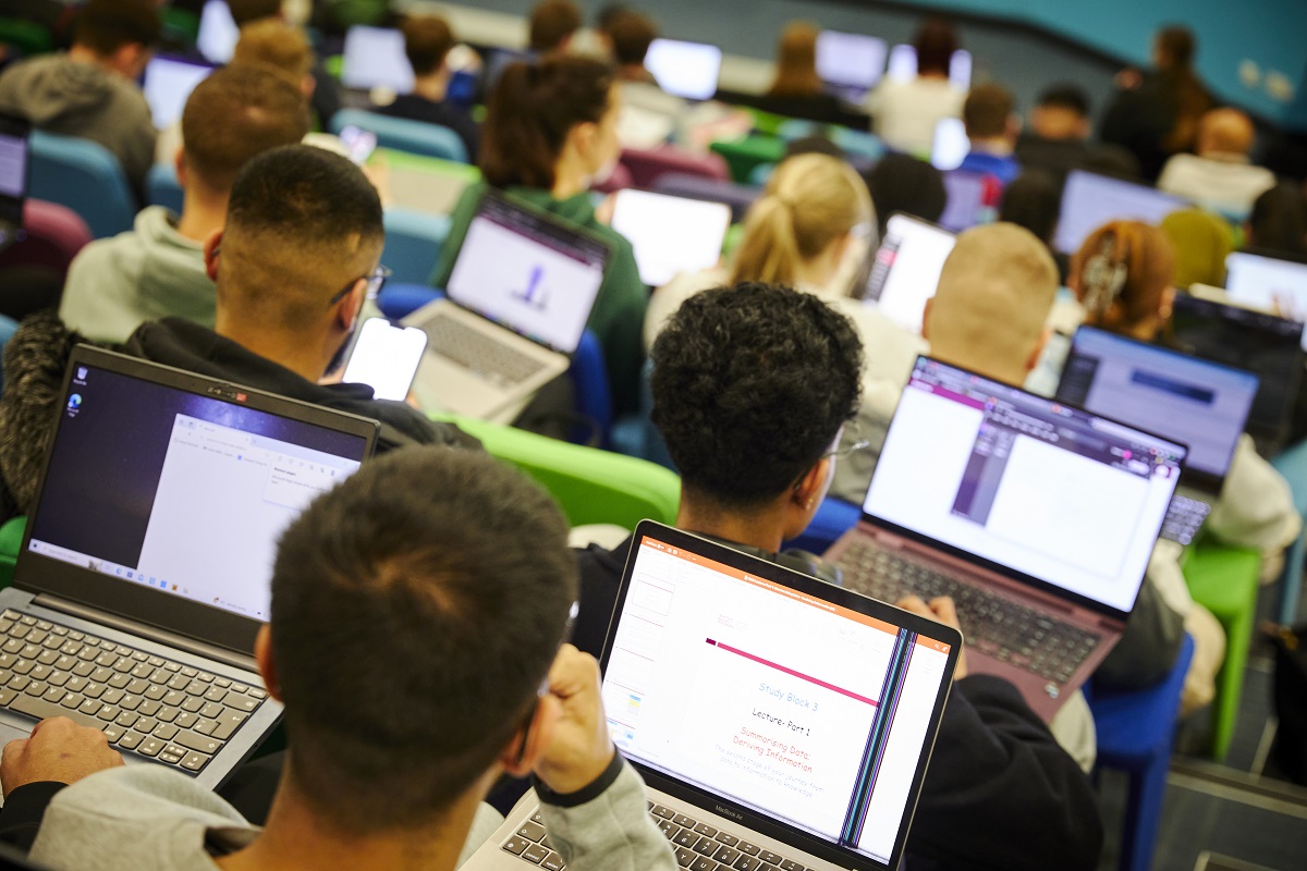  Students sat in a lecture hall with their computers