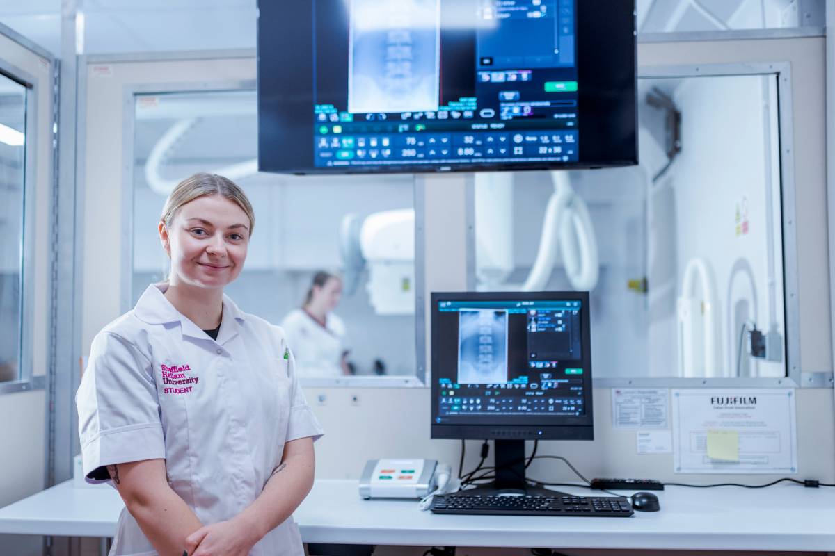 Student in front of diagnostic equipment
