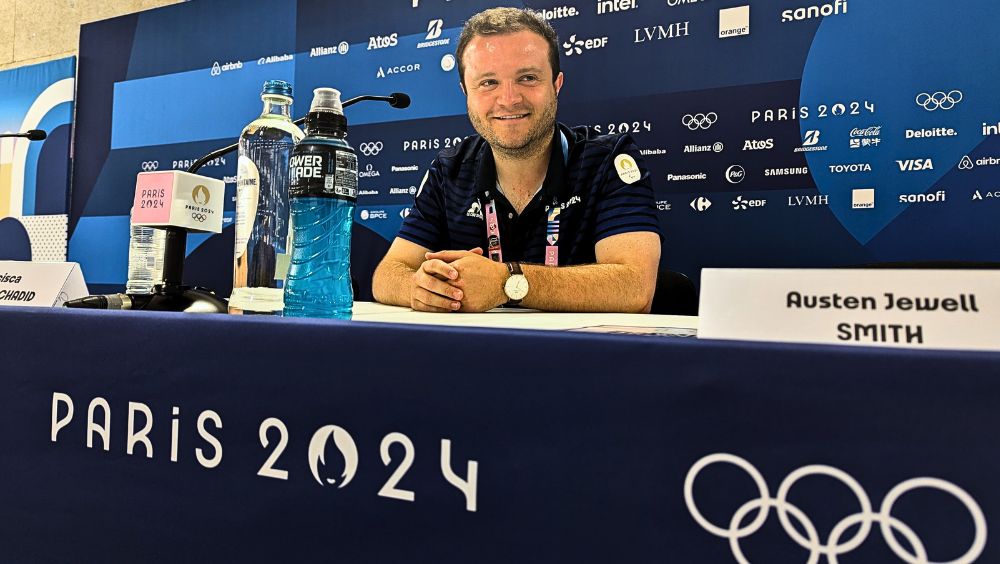 Luke Williams sits on the press table at the Paris Olympics 2024