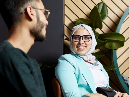 Two people chatting working together