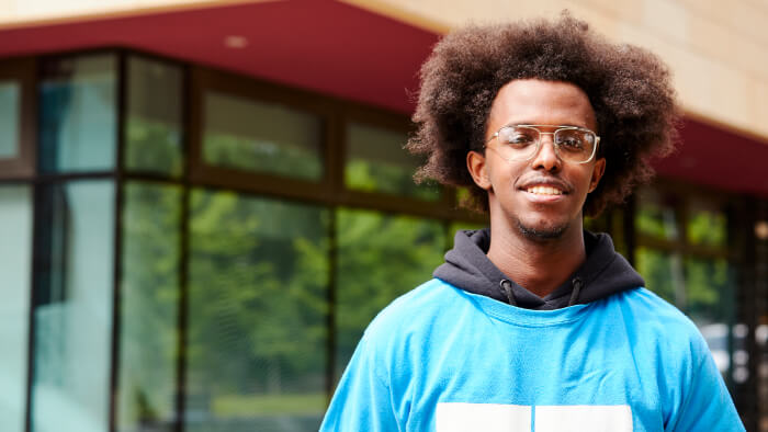 A student ambassador is smiling at camera.