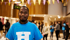 A student ambassador stands looking at the camera in the sheffield hallam atrium