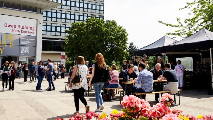 Students exploring various stalls in Hallam Square.