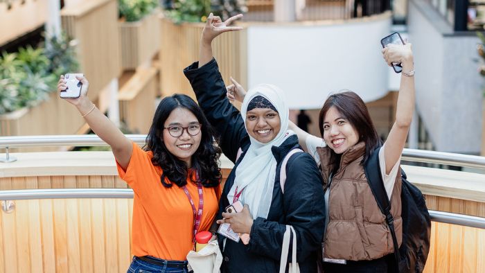 A group of student happy and waving