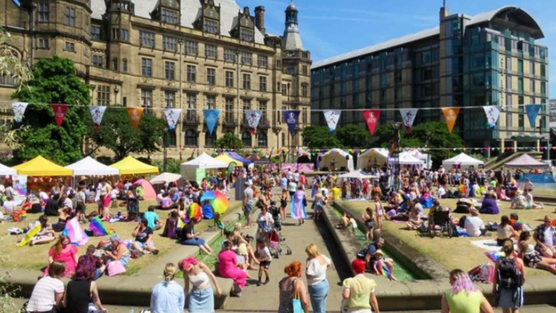 Image of the peace gardens full of people, stalls and flags for the Pinknic event