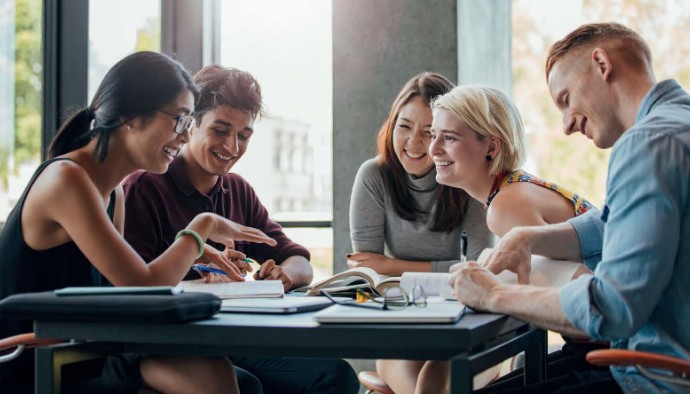 A group of students talking around a table